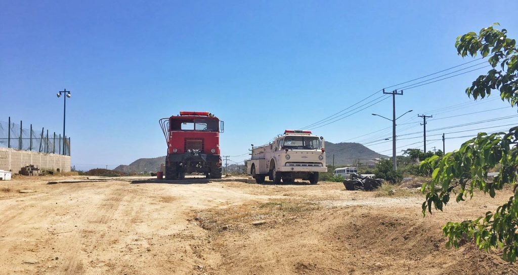 Old fire trucks on the sides of Ave. Los Cabos, Jacarandas